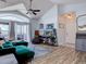 Bright living room featuring vaulted ceilings, hardwood floors, and a green sectional sofa at 14221 E 1St Dr # 304, Aurora, CO 80011