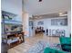 Open living room with hardwood floors and views into the kitchen and dining area at 14221 E 1St Dr # 304, Aurora, CO 80011