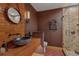 Rustic bathroom features vessel sink, wood counter and walk-in shower at 7088 Indian Peaks Trl, Boulder, CO 80301