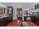 Bathroom with dual vanities, dark wood cabinets, and a decorative mirror at 7088 Indian Peaks Trl, Boulder, CO 80301
