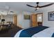 Comfortable bedroom featuring a ceiling fan, television, and doorway to the game room at 7088 Indian Peaks Trl, Boulder, CO 80301