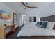 Bedroom featuring a queen bed, window with shutters, and a TV at 7088 Indian Peaks Trl, Boulder, CO 80301