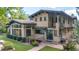 Exterior home architecture featuring patio, lawn, grill, and manicured landscaping at 7088 Indian Peaks Trl, Boulder, CO 80301