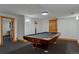 Enjoy a classic game of pool in this well-lit room with stylish carpeting and wood accents at 7088 Indian Peaks Trl, Boulder, CO 80301