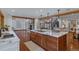 Open kitchen with a large island, marble countertops, and dark wood cabinetry at 7088 Indian Peaks Trl, Boulder, CO 80301