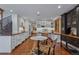 Expansive kitchen and dining area with hardwood floors, white cabinetry, and stylish decor at 7088 Indian Peaks Trl, Boulder, CO 80301