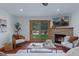 Cozy living room with stone fireplace and sliding doors to backyard at 7088 Indian Peaks Trl, Boulder, CO 80301