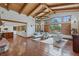 Spacious living room with vaulted ceilings, wood beams, large windows, and an open floor plan at 7088 Indian Peaks Trl, Boulder, CO 80301