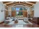 Bright living room with large windows, wood floors, vaulted ceilings, and stylish furnishings at 7088 Indian Peaks Trl, Boulder, CO 80301