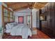 Elegant primary bedroom with a four-poster bed, wooden ceiling, and a large closet at 7088 Indian Peaks Trl, Boulder, CO 80301
