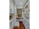 Well-organized pantry with custom shelving, drawers, and a window for natural light at 7088 Indian Peaks Trl, Boulder, CO 80301