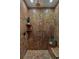 Close up of shower with tiled walls, seat, and various toiletries at 7088 Indian Peaks Trl, Boulder, CO 80301