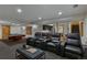 A spacious theater room features tiered seating, a wet bar, and an adjacent game area at 7088 Indian Peaks Trl, Boulder, CO 80301