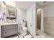 Bathroom features gray tiling, a shower with glass doors, and modern fixtures at 3801 S Joplin St, Aurora, CO 80013