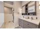 Elegant bathroom featuring a double vanity, a glass-enclosed shower, and stylish finishes at 3801 S Joplin St, Aurora, CO 80013