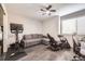 Comfortable room with gray walls, features a pullout couch, computer desk, and exercise bike at 3801 S Joplin St, Aurora, CO 80013