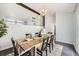 Light-filled dining room showcasing a wooden table, black chairs, and a decorative chandelier at 3801 S Joplin St, Aurora, CO 80013