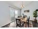 Bright dining room with a wood table, black chairs, and sliding glass doors to the exterior at 3801 S Joplin St, Aurora, CO 80013