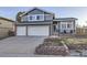 Charming two-story home with blue siding, brick accents, and well-maintained front yard landscaping at 3801 S Joplin St, Aurora, CO 80013