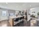 Modern kitchen features stainless steel appliances, a stylish island with bar seating, and gray cabinetry at 3801 S Joplin St, Aurora, CO 80013