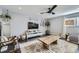 Cozy living room featuring dark wood floors, a ceiling fan, a large rug, and modern decor at 3801 S Joplin St, Aurora, CO 80013