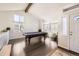 Spacious living area with high ceilings, ample windows, a pool table, and wood floors at 3801 S Joplin St, Aurora, CO 80013