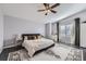 Inviting main bedroom with a ceiling fan, a plush bed, and a view of the backyard at 3801 S Joplin St, Aurora, CO 80013