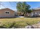 Expansive backyard features a lush lawn, mature trees, and a patio perfect for outdoor gatherings at 6902 S Jackson Way, Centennial, CO 80122