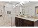 Elegant bathroom with stone tile shower, granite counters with dual sinks, and modern fixtures at 6902 S Jackson Way, Centennial, CO 80122