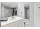 This is a bright and modern bathroom with a large mirror and a shower and tub with tile surround at 6902 S Jackson Way, Centennial, CO 80122