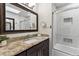 Bathroom featuring granite countertops, a modern vanity, and a tiled shower behind a sliding glass door at 6902 S Jackson Way, Centennial, CO 80122
