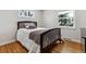 This bedroom has hardwood floors, is brightly lit, and offers serene views from two windows at 6902 S Jackson Way, Centennial, CO 80122