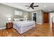 Generous bedroom with hardwood floors, ceiling fan, neutral tones, and an ensuite closet at 6902 S Jackson Way, Centennial, CO 80122