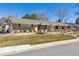 Single-story home featuring a well-manicured front yard, a welcoming entrance, and an attached garage at 6902 S Jackson Way, Centennial, CO 80122