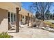 Inviting covered front porch features stylish stone tile, charming brown columns and lush landscaping at 6902 S Jackson Way, Centennial, CO 80122