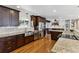 Beautiful gourmet kitchen featuring stainless steel appliances, granite countertops, and dark wooden cabinets at 6902 S Jackson Way, Centennial, CO 80122