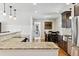 Open kitchen featuring granite countertops, stainless steel appliances, and an adjacent dining area at 6902 S Jackson Way, Centennial, CO 80122