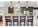 Modern kitchen featuring granite countertops, pendant lighting, and stainless steel appliances with eat-in bar at 6902 S Jackson Way, Centennial, CO 80122