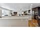 Spacious open-concept design seamlessly connects the kitchen, living area and features hardwood floors at 6902 S Jackson Way, Centennial, CO 80122