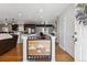 Open-concept entryway featuring hardwood floors, mountain-themed stairwell, and seamless access to kitchen at 6902 S Jackson Way, Centennial, CO 80122