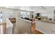 Open-concept design blending the entryway, living space, and kitchen featuring hardwood floors and natural light at 6902 S Jackson Way, Centennial, CO 80122
