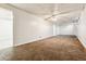 Spacious basement featuring neutral walls, carpet flooring, and a ceiling fan at 14830 Robins Dr, Denver, CO 80239