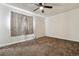 Cozy bedroom featuring a ceiling fan and a window with curtains for privacy at 14830 Robins Dr, Denver, CO 80239