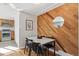 Dining area with wood accent wall and marble table at 6125 Brentwood St, Arvada, CO 80004