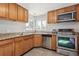 Updated kitchen featuring stainless steel appliances and granite countertops at 6125 Brentwood St, Arvada, CO 80004