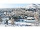 Scenic aerial view of a neighborhood covered in snow with mountains in the distance provides a peaceful and picturesque setting at 14080 Crabapple Rd, Golden, CO 80401