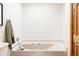Clean bathroom featuring a bathtub and classic design for a peaceful and functional space at 14080 Crabapple Rd, Golden, CO 80401