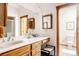 Bright bathroom with wooden cabinets, double sinks, and white countertops for a clean, welcoming space at 14080 Crabapple Rd, Golden, CO 80401