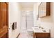 Bathroom with shower, sink with vanity, mirror, and wood door at 14080 Crabapple Rd, Golden, CO 80401