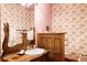 Elegant powder room featuring a wood vanity with vessel sink and unique wallpaper at 14080 Crabapple Rd, Golden, CO 80401